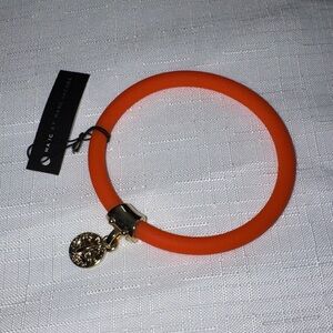 Marc by Marc Jacobs orange silicone bracelet  with Gold Charm